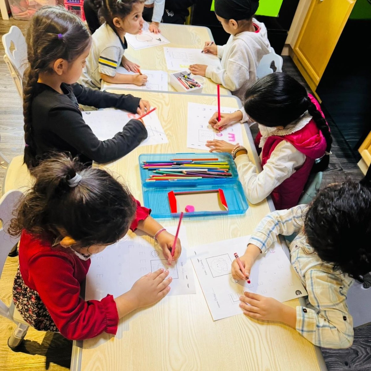 Children working on activities together at a table